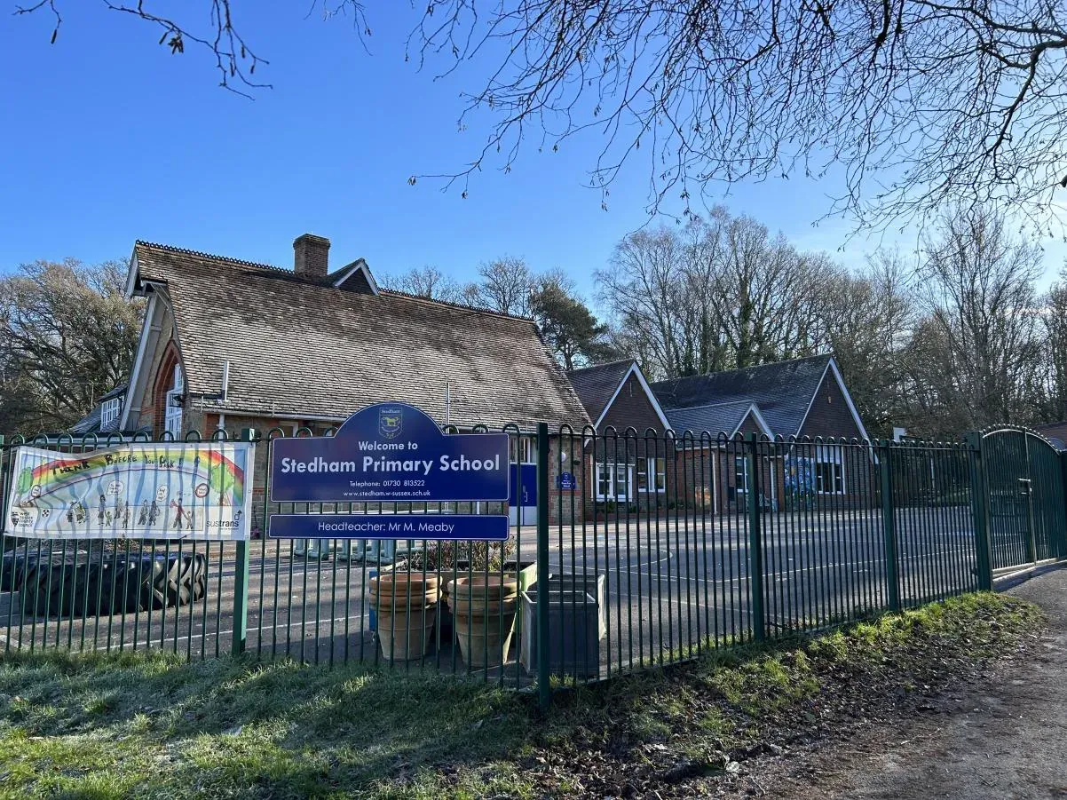 The school entrance gates and sign on a bright winter day