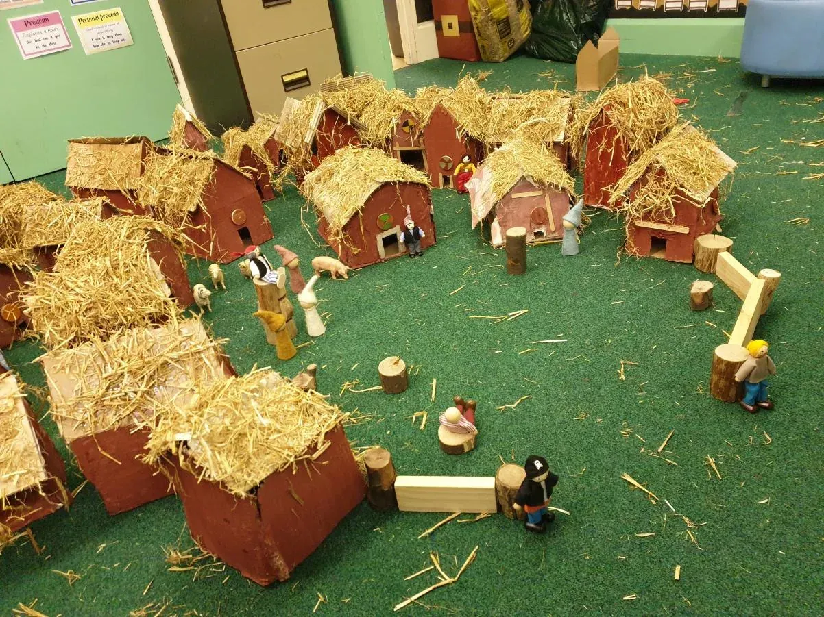 A small-world farm built from wooden blocks and straw in the Early Years classroom